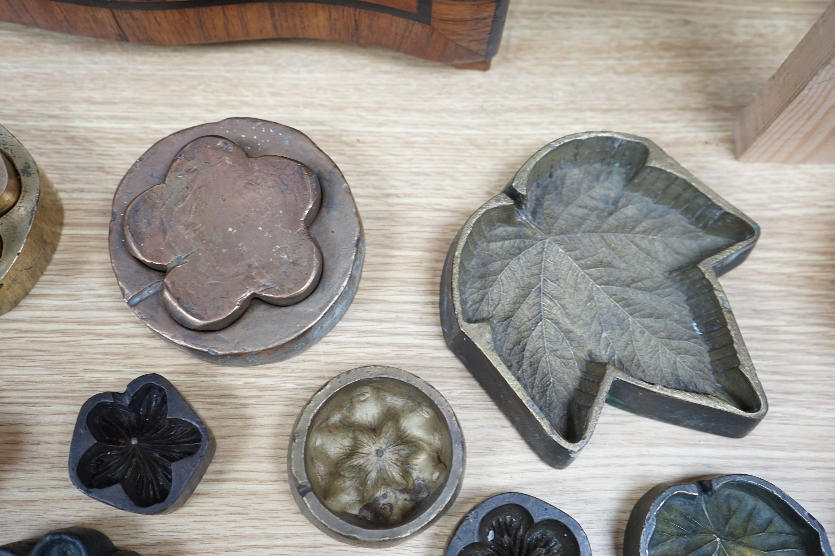 A collection of metal pattern moulds possibly for embossing silk (19) and two other moulds